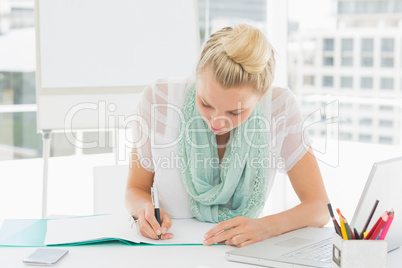 Casual young woman writing notes