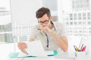 Casual young man reading document