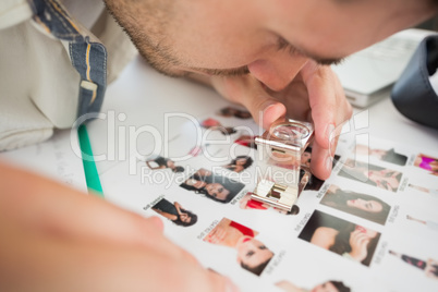 Closeup of a concentrate male artist looking at photos