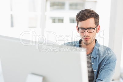 Concentrated young male artist using computer