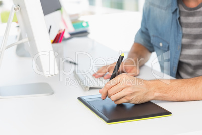 Casual male photo editor using graphics tablet