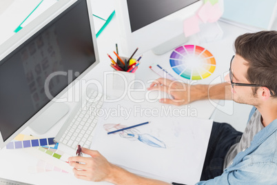 Casual male photo editor using computer