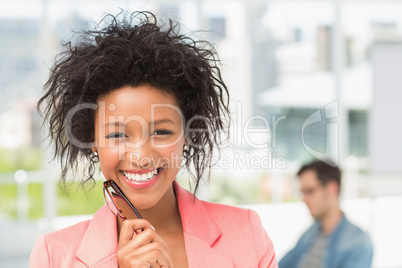 Closeup of a casual female artist with colleague at office