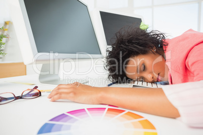 Female artist with head resting on keyboard