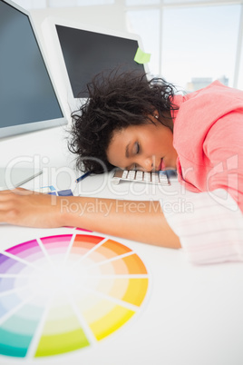 Female artist with head resting on keyboard