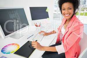 Casual female photo editor using computer