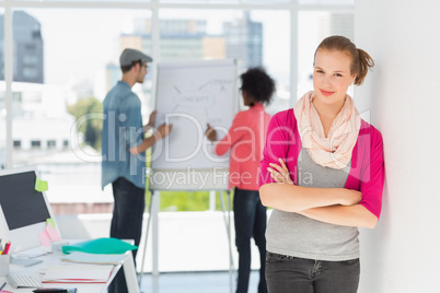 Casual artist with colleagues in background at office