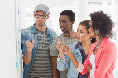 Artists in discussion in front of whiteboard