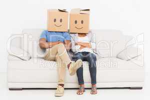 Young couple with happy smiley boxes over faces
