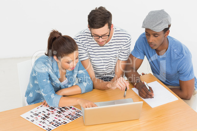 Concentrated artists working on laptop at the office