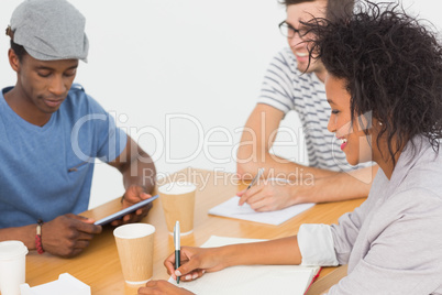 Group of happy artists in discussion at desk