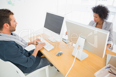 Young man and woman working on computers