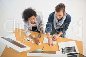 Young couple working on computer in office