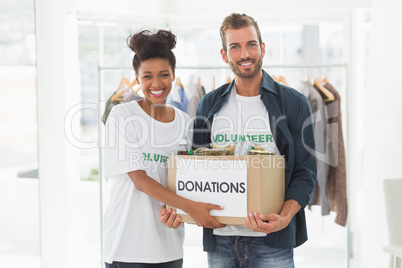 Smiling young couple with clothes donation