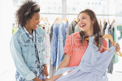Happy women shopping in clothes store