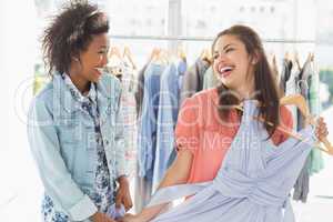 Happy women shopping in clothes store