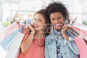 Young women with shopping bags in clothes store