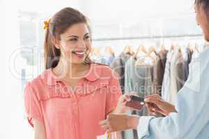 Customer receiving credit card from saleswoman