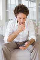 Relaxed man text messaging at home