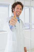Handsome male doctor gesturing thumbs up