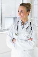 Beautiful female doctor with arms crossed in hospital