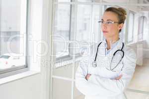 Serious female doctor with arms crossed in hospital