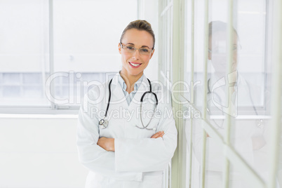 Beautiful female doctor with arms crossed in hospital