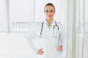 Beautiful female doctor with clipboard in hospital