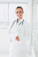 Beautiful female doctor with clipboard in hospital