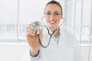 Smiling female doctor with stethoscope in hospital