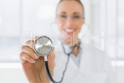 Blurred smiling female doctor with stethoscope
