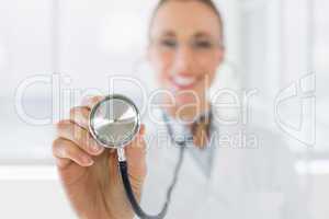 Blurred smiling female doctor with stethoscope