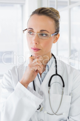 Contemplative beautiful female doctor in hospital