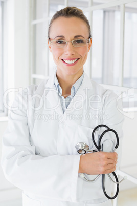 Smiling female doctor with stethoscope in hospital