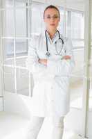 Serious female doctor with arms crossed in hospital