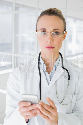 Portrait of a female doctor reading text message Portrait of a female doctor reading text message