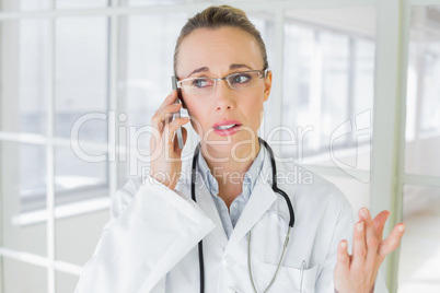 Beautiful female doctor using mobile phone Beautiful female doctor using mobile phone