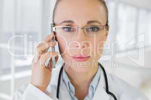Closeup of a beautiful female doctor using mobile phone