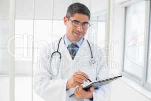 Portrait of a male doctor writing reports