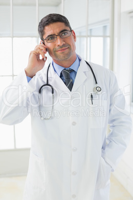 Male doctor using mobile phone in hospital