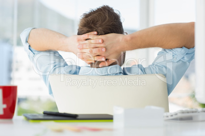 Handsome designer relaxing at his desk