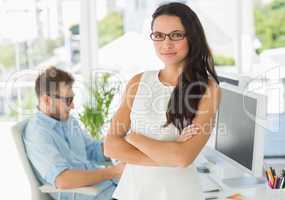 Pretty designer looking at camera leaning on desk