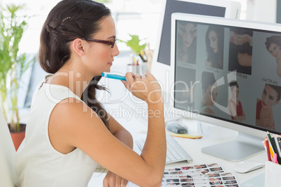 Focused young editor working at her desk