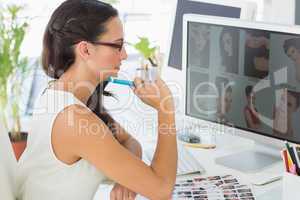 Focused young editor working at her desk