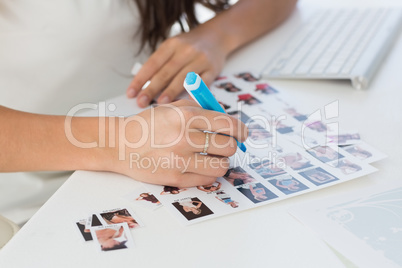 Editor working at her desk marking a contact sheet