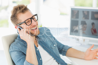 Editor talking on the phone at his desk