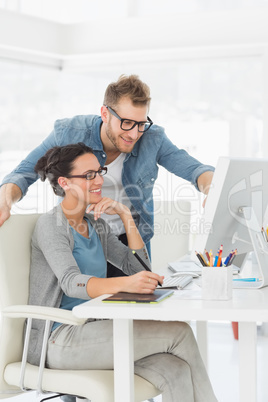 Young design team working at desk looking at computer