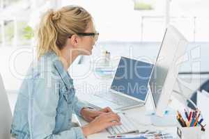 Blonde designer working at her desk