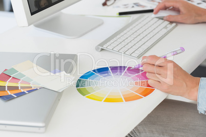 Designer working at her desk using a colour wheel