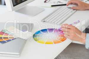Designer working at her desk using a colour wheel